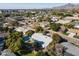 Aerial view of a home with mountain views, mature trees and a backyard pool at 3511 E Elm St, Phoenix, AZ 85018