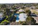 Aerial view of backyard with sparkling pool, mature trees, and neighborhood view at 3511 E Elm St, Phoenix, AZ 85018