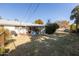 Spacious backyard view showing the back of the house, a mix of greenery and open space for outdoor activities and relaxation at 3511 E Elm St, Phoenix, AZ 85018