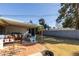 Backyard featuring a covered patio with open space and a brick surface, perfect for outdoor gatherings and relaxation at 3511 E Elm St, Phoenix, AZ 85018