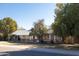 Charming single story home with mature trees, a covered porch, and lush landscaping at 3511 E Elm St, Phoenix, AZ 85018