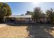 Well-maintained home with covered porch, mature trees, and tidy landscaping at 3511 E Elm St, Phoenix, AZ 85018