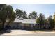 Exterior of home with a long driveway and carport, featuring a cozy covered front porch at 3511 E Elm St, Phoenix, AZ 85018