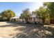 Exterior of a single-story home featuring a covered porch and a well-maintained front lawn at 3511 E Elm St, Phoenix, AZ 85018