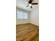 Bright bedroom featuring laminate flooring, a window with blinds, and ceiling fan at 3810 N Maryvale Pkwy # 1068, Phoenix, AZ 85031