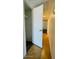 Hallway featuring laminate flooring, an open door to the closet, and neutral-colored walls at 3810 N Maryvale Pkwy # 1068, Phoenix, AZ 85031