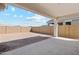 Spacious backyard with covered patio and privacy wall, perfect for outdoor entertaining and relaxation at 39965 W Venture Rd, Maricopa, AZ 85138