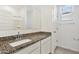 Bright bathroom featuring a granite countertop, single sink vanity and a large mirror at 39965 W Venture Rd, Maricopa, AZ 85138