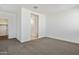 Spacious bedroom with neutral carpet and a doorway leading to a bright en-suite bathroom at 39965 W Venture Rd, Maricopa, AZ 85138