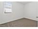 Cozy bedroom with neutral carpet, a window with blinds, and ample natural light at 39965 W Venture Rd, Maricopa, AZ 85138