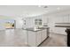 Open kitchen layout with island, stainless dishwasher, granite countertops, and view of the sliding door at 39965 W Venture Rd, Maricopa, AZ 85138