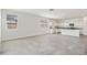 Spacious living room with tile flooring, natural light, and a view of the adjacent kitchen at 39965 W Venture Rd, Maricopa, AZ 85138