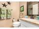 Well-lit bathroom with vanity, tiled mirror, decorative stars, and ample counter space at 4216 E Desert Marigold Dr, Cave Creek, AZ 85331