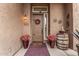 Inviting front door with a seasonal wreath, potted flowers, and a charming welcome mat at 4216 E Desert Marigold Dr, Cave Creek, AZ 85331