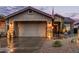 Charming home exterior with a desert landscape, a two-car garage, and stylish lighting fixtures at 4216 E Desert Marigold Dr, Cave Creek, AZ 85331