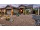 Charming single-Gathering home featuring an inviting desert landscape with decorative rock and various cacti at 4216 E Desert Marigold Dr, Cave Creek, AZ 85331