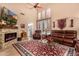 Inviting living room showcasing a stone fireplace and a comfortable leather sofa at 4216 E Desert Marigold Dr, Cave Creek, AZ 85331