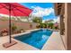 Sparkling blue pool area featuring a waterfall, decorative lights, and inviting patio area at 4216 E Desert Marigold Dr, Cave Creek, AZ 85331