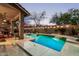 Inviting pool with integrated waterfall, decorative lighting, and outdoor seating for relaxation at 4216 E Desert Marigold Dr, Cave Creek, AZ 85331