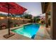 Beautiful pool with a waterfall feature, decorative lighting, and lush landscaping for a resort-like ambiance at 4216 E Desert Marigold Dr, Cave Creek, AZ 85331