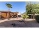 Lush backyard with covered patio, hammock, and beautiful desert landscaping at 42578 W Rosalia Dr, Maricopa, AZ 85138