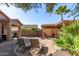 Expansive backyard featuring dual covered patios, mature trees, and gravel accents at 42578 W Rosalia Dr, Maricopa, AZ 85138