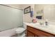 Bright bathroom with a shower/tub combo, single sink vanity and brushed nickel faucet at 42578 W Rosalia Dr, Maricopa, AZ 85138