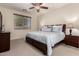 Serene bedroom with neutral tones, patterned bedding, and ample natural light at 42578 W Rosalia Dr, Maricopa, AZ 85138