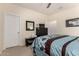 Bedroom with a patterned comforter, mirror, and overhead lighting at 42578 W Rosalia Dr, Maricopa, AZ 85138