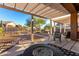 Inviting covered back patio featuring a stylish fire pit and outdoor seating, perfect for relaxing and entertaining at 4267 S Strong Box Rd, Gold Canyon, AZ 85118