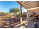 Beautiful backyard featuring a covered patio, desert landscaping, and ample space for outdoor activities at 4267 S Strong Box Rd, Gold Canyon, AZ 85118