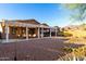 Expansive backyard with a covered patio, desert landscaping, and a serene mountain backdrop at 4267 S Strong Box Rd, Gold Canyon, AZ 85118