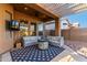 Relaxing covered patio with comfortable outdoor seating and a fire pit at 4267 S Strong Box Rd, Gold Canyon, AZ 85118