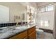 Bathroom with a single sink, granite countertop, wood cabinets, and a shower-tub combination at 4267 S Strong Box Rd, Gold Canyon, AZ 85118