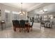 Elegant dining room features a chandelier, tile flooring and an open layout to the living area at 4267 S Strong Box Rd, Gold Canyon, AZ 85118