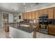 Spacious kitchen with island, stainless appliances and tiled floors at 4267 S Strong Box Rd, Gold Canyon, AZ 85118