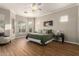 Spacious bedroom featuring a king-size bed, wood floors, and ample natural light from the many windows at 4267 S Strong Box Rd, Gold Canyon, AZ 85118