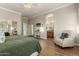 Well-lit main bedroom boasts wood floors, stylish furnishings, and an ensuite bathroom at 4267 S Strong Box Rd, Gold Canyon, AZ 85118