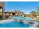 Resort-style pool and spa with lush landscaping and an outdoor kitchen, perfect for entertaining at 4502 E Night Owl Ln, Cave Creek, AZ 85331