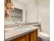 Bright bathroom featuring a single sink vanity and a large mirror with a washing machine visible in the reflection at 4683 W Dublin St, Chandler, AZ 85226