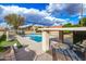 Community pool area featuring pool with lounge chairs and mature landscaping in a residential setting at 4683 W Dublin St, Chandler, AZ 85226