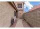 Walkway along a tan stucco home with desert landscaping and a glimpse of blue sky at 4683 W Dublin St, Chandler, AZ 85226