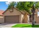 Exterior view of a tan home with a brown garage door and a well-maintained green lawn at 4683 W Dublin St, Chandler, AZ 85226