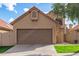 Attached garage with brown door and driveway of a tan stucco home under a partly cloudy sky at 4683 W Dublin St, Chandler, AZ 85226