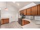 Functional kitchen with wood cabinets, tile floors, modern appliances, and ample counter space at 4683 W Dublin St, Chandler, AZ 85226