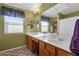 Bathroom featuring double sinks, a large mirror, and natural light at 474 E Baylor Ln, Gilbert, AZ 85296