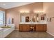 Bright bathroom features a double vanity, soaking tub, and large mirrors at 474 E Baylor Ln, Gilbert, AZ 85296