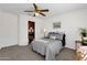 Bright bedroom with a ceiling fan and closet featuring custom shelving for organized storage at 474 E Baylor Ln, Gilbert, AZ 85296