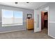 Bedroom with a large window, carpet, and a built-in closet featuring custom shelving at 474 E Baylor Ln, Gilbert, AZ 85296