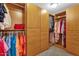 Walk-in closet features custom wooden shelving for optimal storage space at 474 E Baylor Ln, Gilbert, AZ 85296